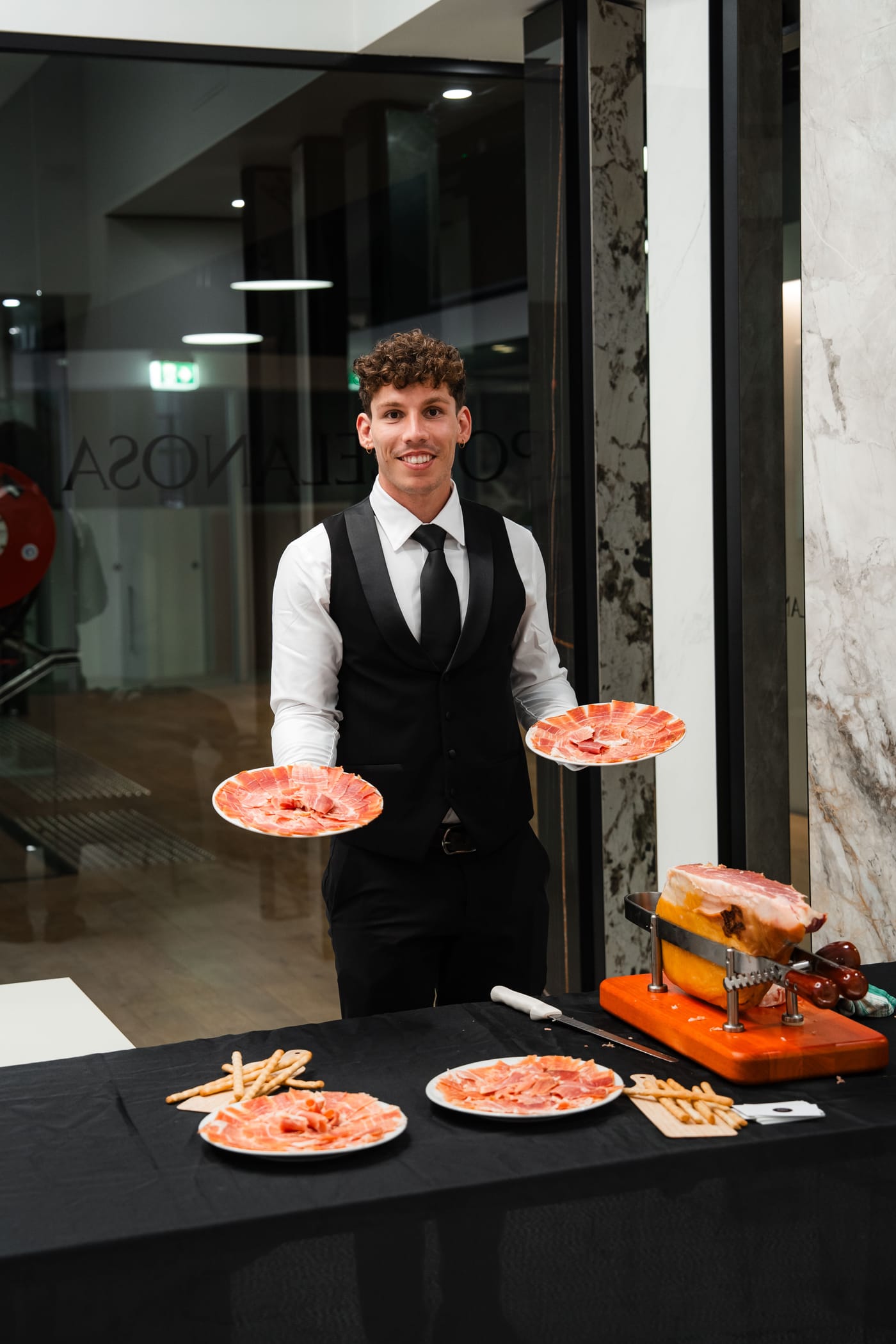 Iberico Sydney waiter presenting plates of jamón